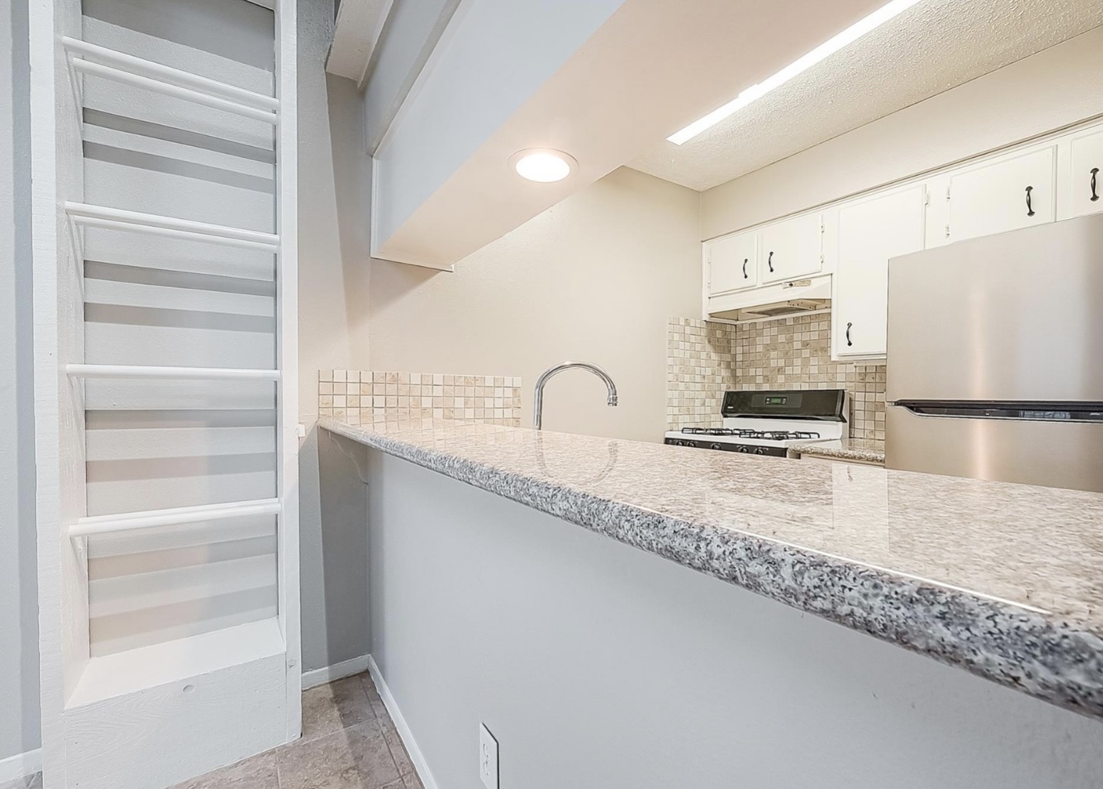 1108 West Tri Oaks Lane, Unit 150 Houston, TX 77043 - Photo 21 of 26 a close view of a sink and a refrigerator