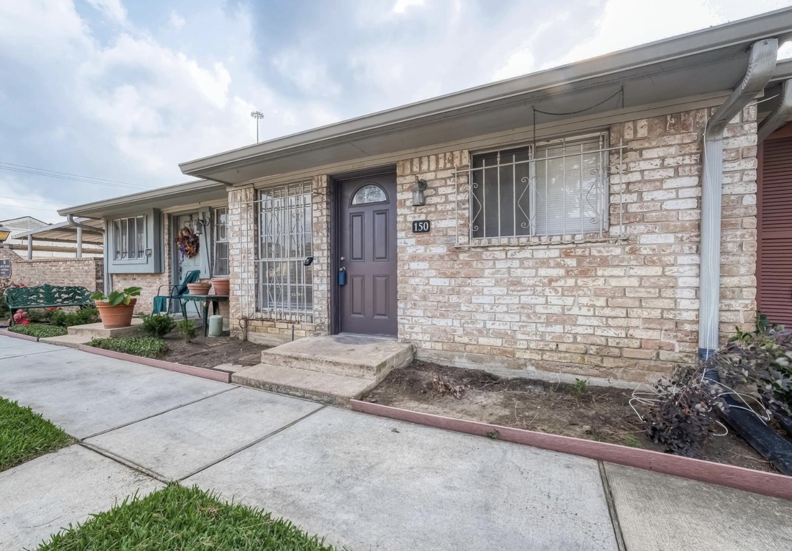 1108 West Tri Oaks Lane, Unit 150 Houston, TX 77043 - Photo 4 of 26 a front view of a house with a patio