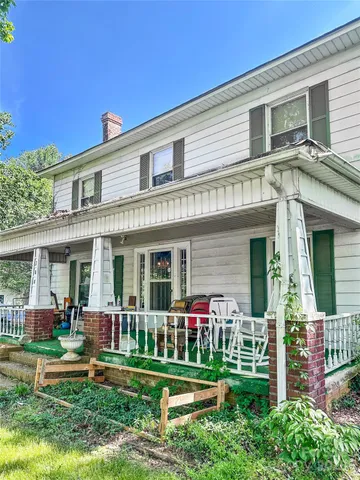 a living room with chairs and a table