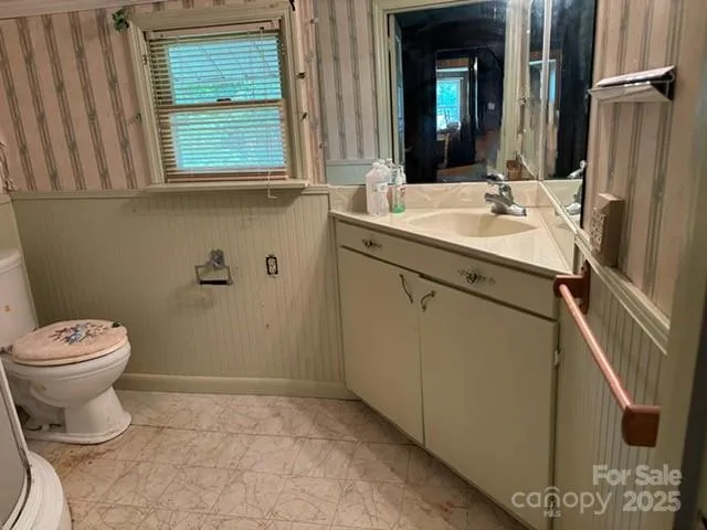 a view of a livingroom with bathroom and shower