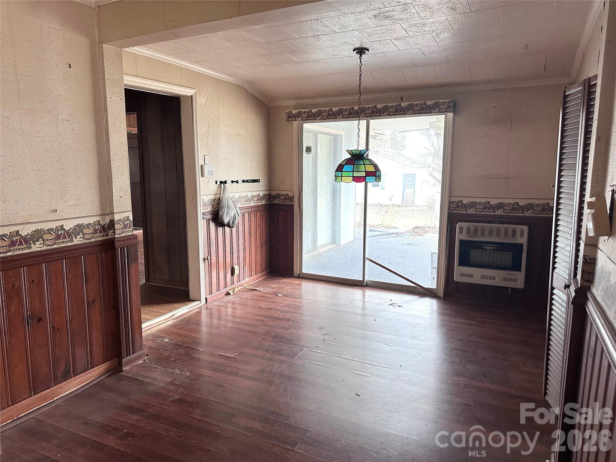 208 East Main Street Cleveland, NC 27013 - Photo 36 of 48 an empty room with wooden floor a fireplace and entryway