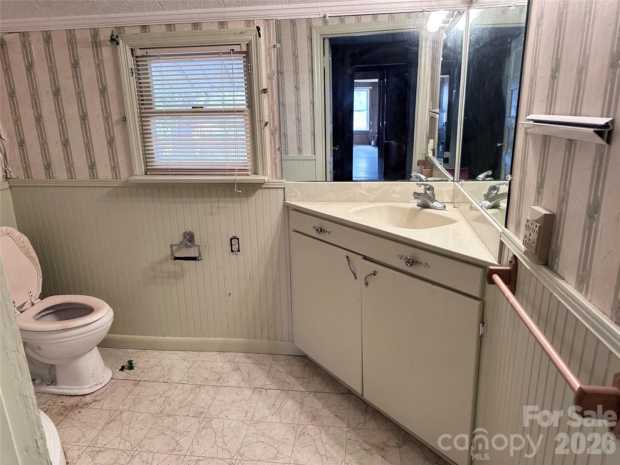 208 East Main Street Cleveland, NC 27013 - Photo 37 of 48 a bathroom with a toilet sink and mirror