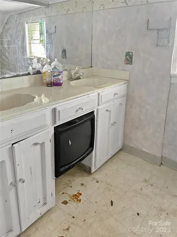 a kitchen with a sink window and cabinets
