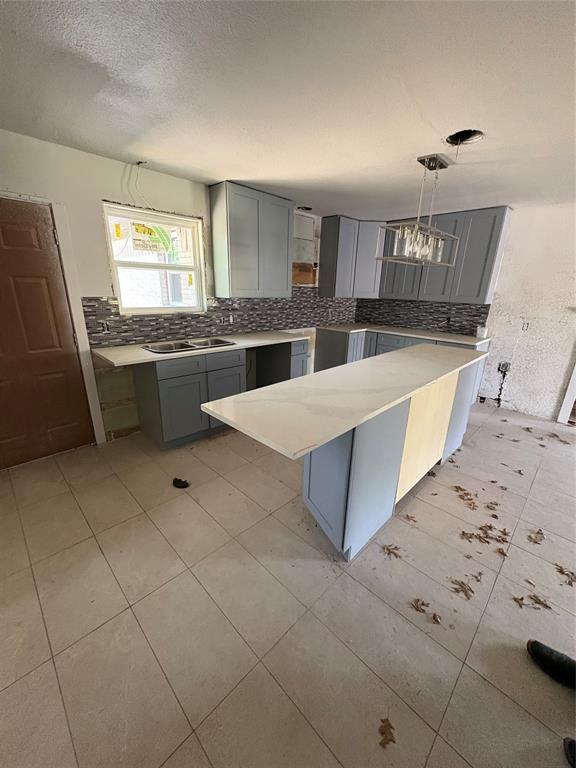 2306 Greenland Drive Dallas, TX 75228 - Photo 8 of 18 a large kitchen with kitchen island granite countertop a sink a counter space and cabinets