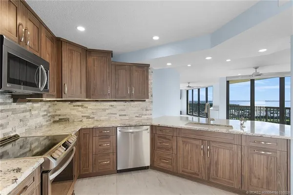 a view of a livingroom with a dinning area hardwood floor and a kitchen space