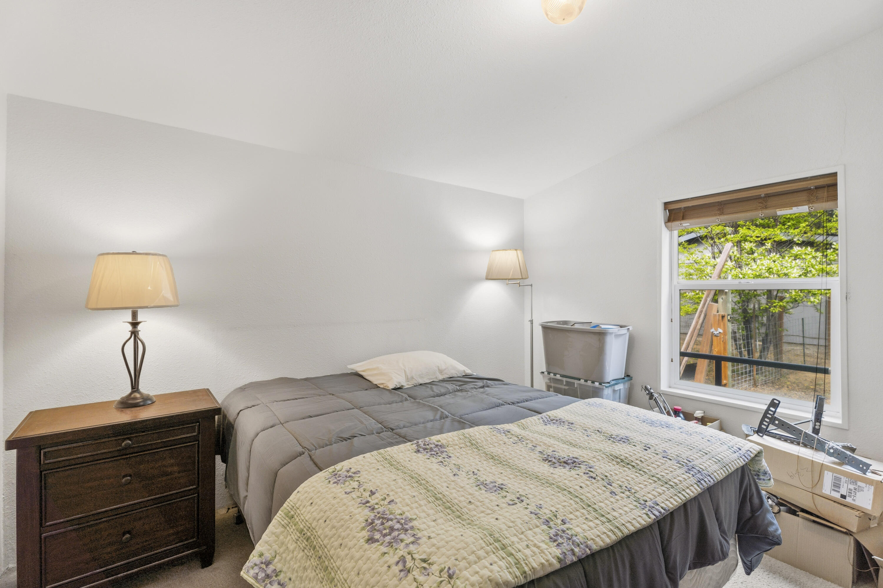 16928 Covina Road Bend, OR 97707 - Photo 21 of 48 a bedroom with a bed and a chandelier