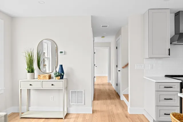 a view of living room with furniture and mirror