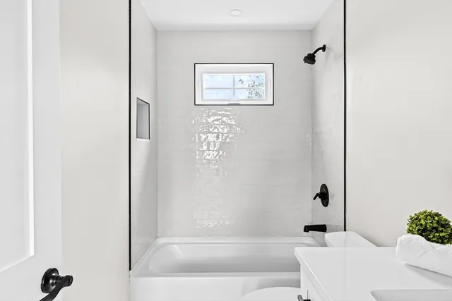 a bathroom with a bathtub and shower
