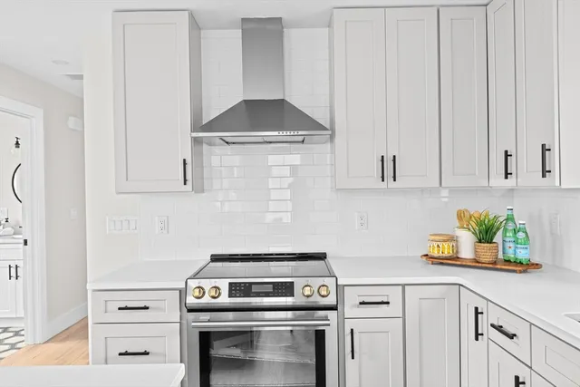a kitchen with a stove and cabinets