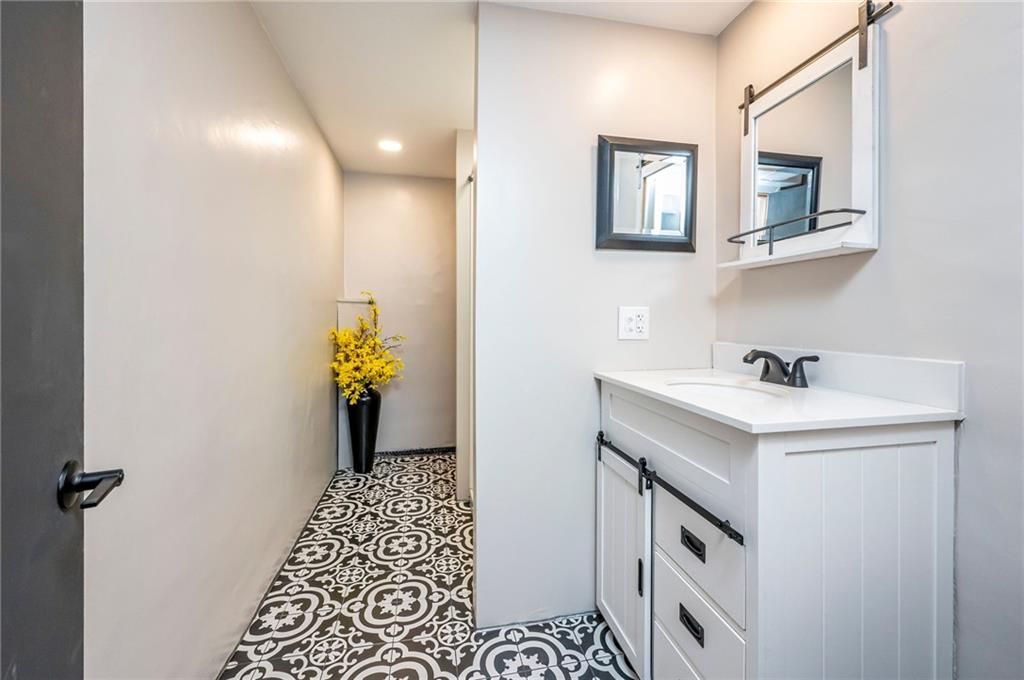 630 Bascom Avenue Pittsburgh, PA 15212 - Photo 21 of 25 a bathroom with a sink a vanity and a mirror