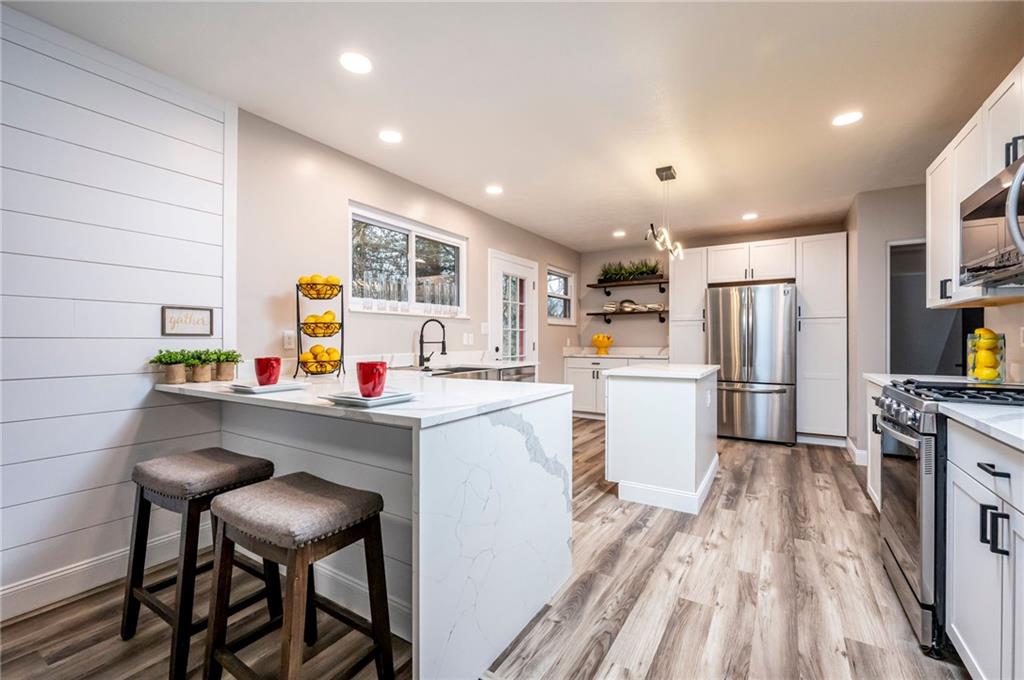 630 Bascom Avenue Pittsburgh, PA 15212 - Photo 7 of 25 a kitchen with white cabinets and stainless steel appliances