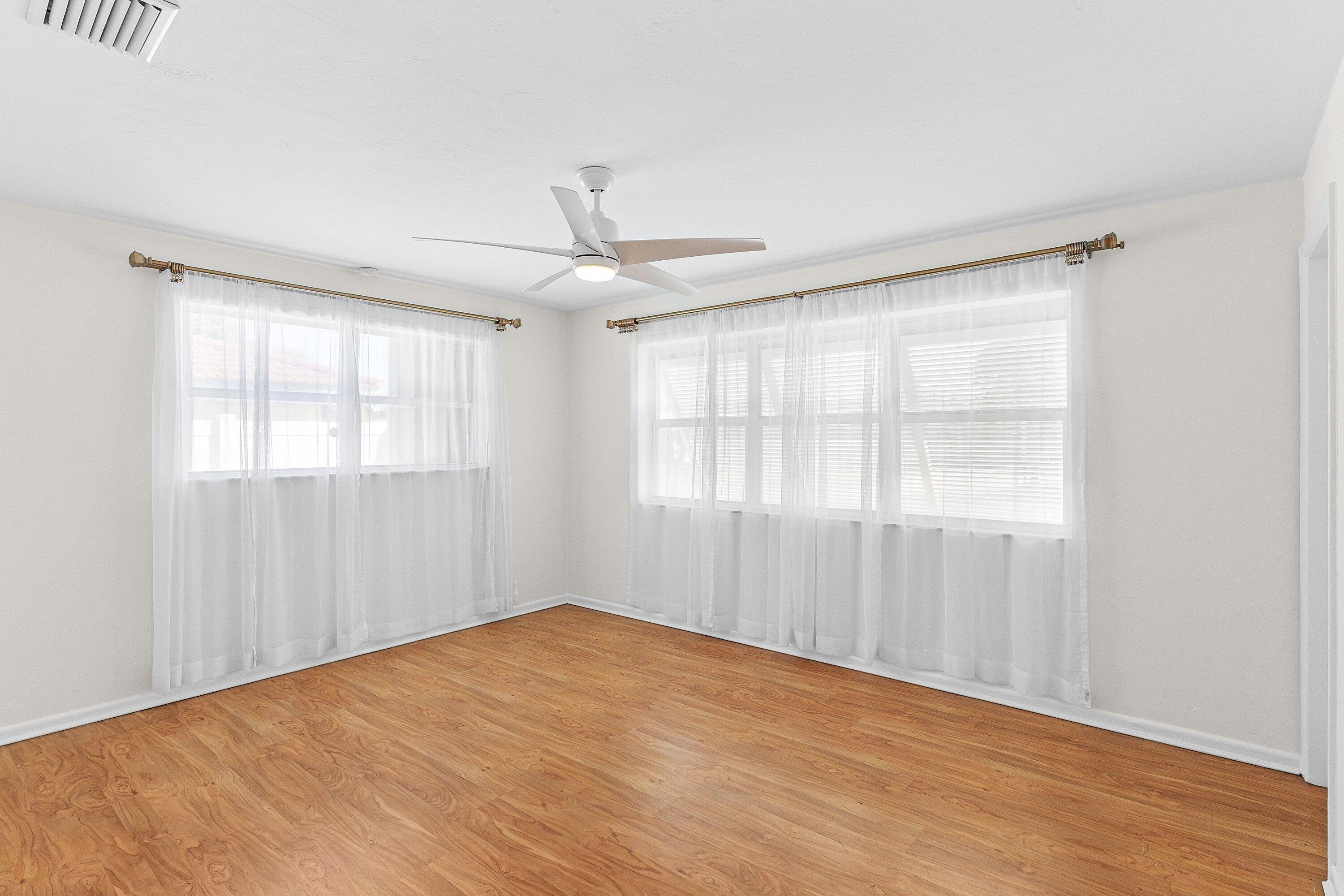451 Northeast 25th Terrace Boca Raton, FL 33431 - Photo 20 of 47 an empty room with wooden floor fan and windows