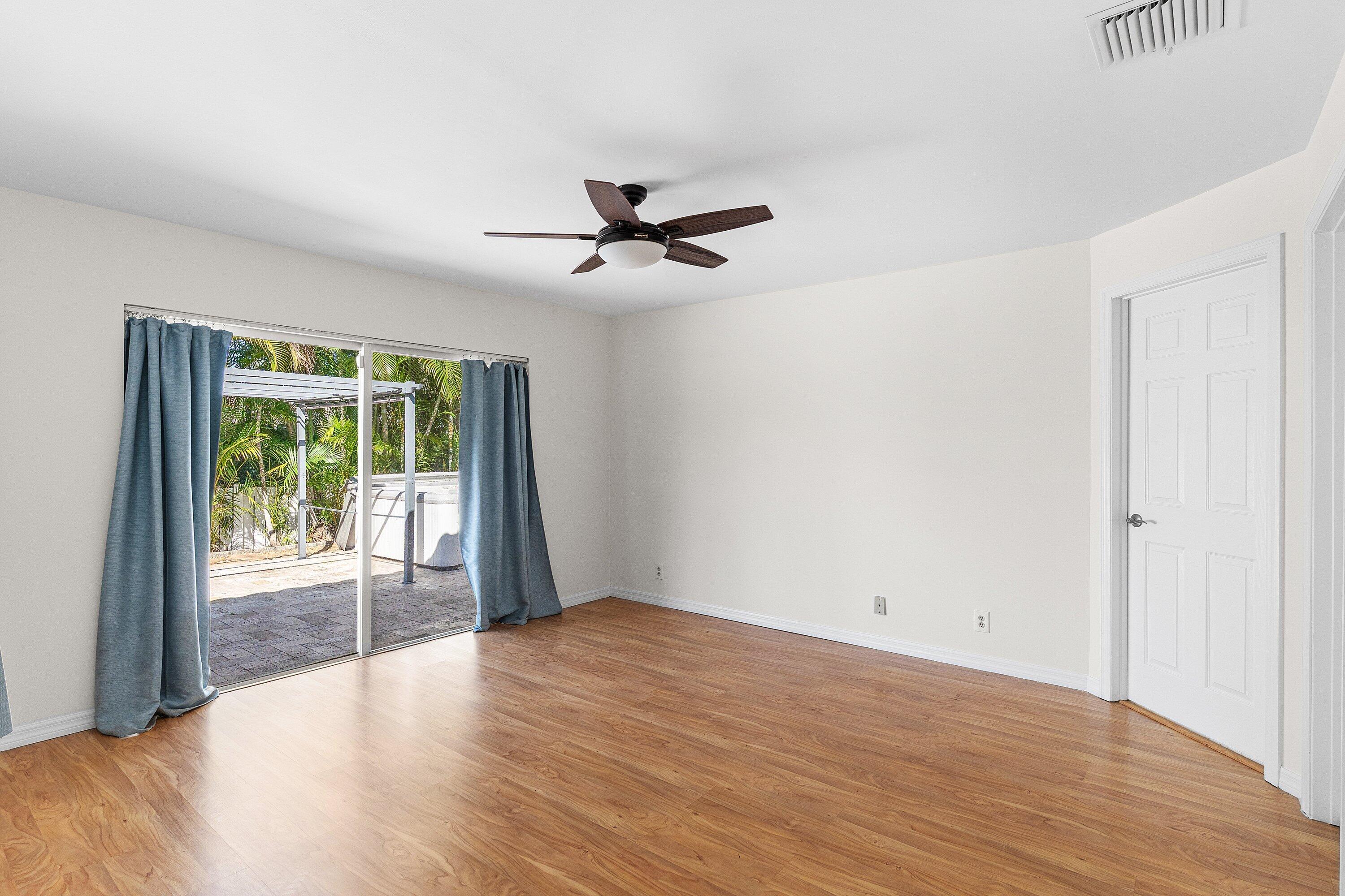 451 Northeast 25th Terrace Boca Raton, FL 33431 - Photo 22 of 47 wooden floor in an empty room with a window
