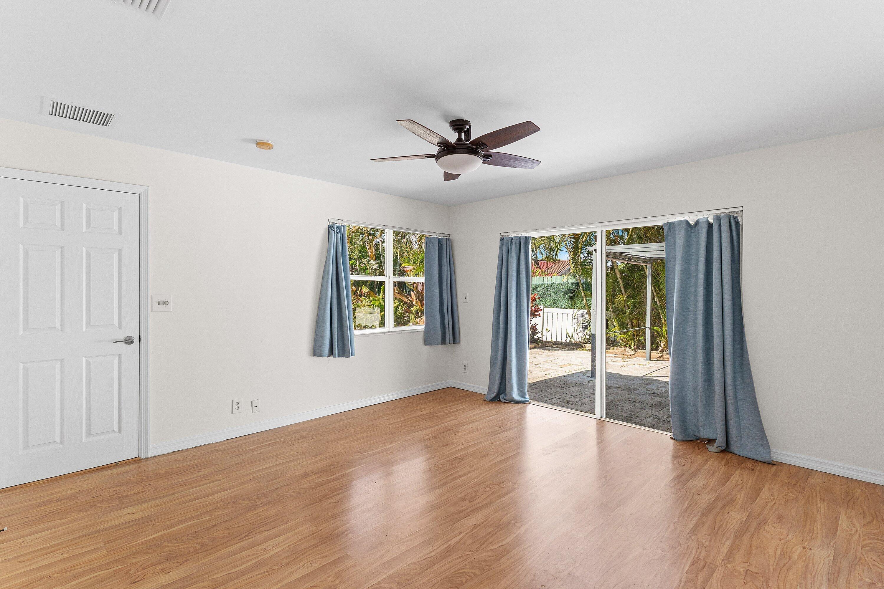451 Northeast 25th Terrace Boca Raton, FL 33431 - Photo 23 of 47 wooden floor in an empty room with a window
