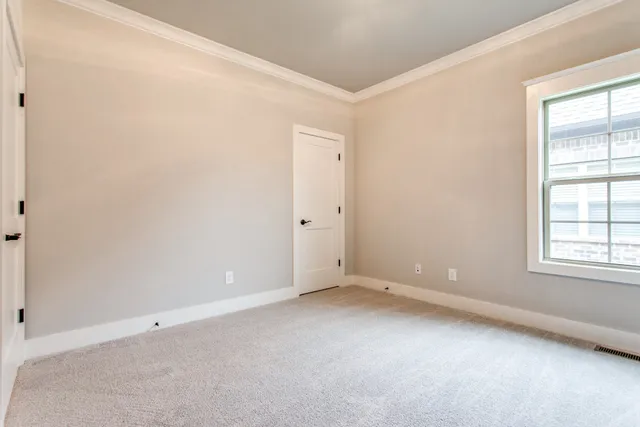 an empty room with windows and closet