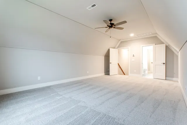 an empty room with a ceiling fan and a window