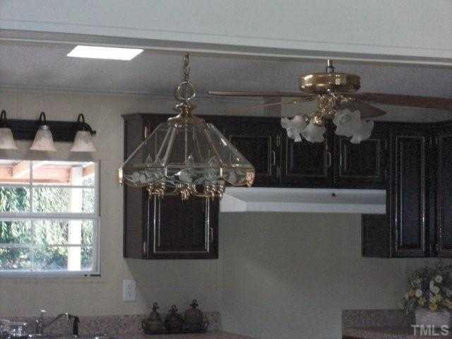 Updated light fixtures and ceiling fan in kitchen and dining area
