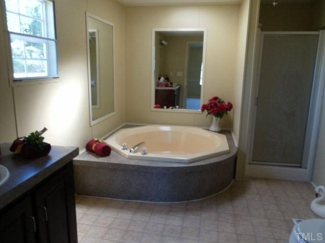 299 Al Gray Road Timberlake, NC 27583 - Photo 8 of 16 Master bath offers new soaking tub with separate shower and new vinyl flooring