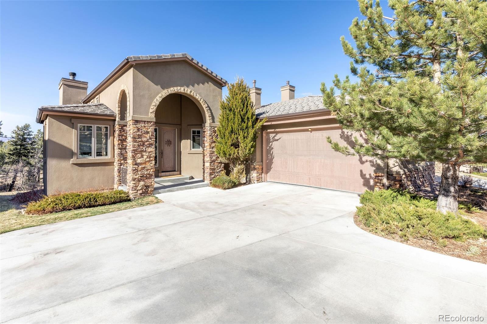 968 Summer Spring View Colorado Springs, CO 80906 - Photo 1 of 40 a front view of a house with a garden
