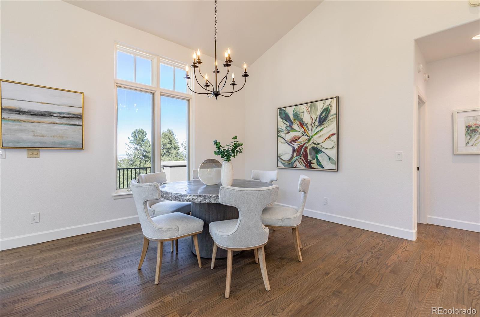 968 Summer Spring View Colorado Springs, CO 80906 - Photo 17 of 40 a view of a dining room with furniture wooden floor and chandelier