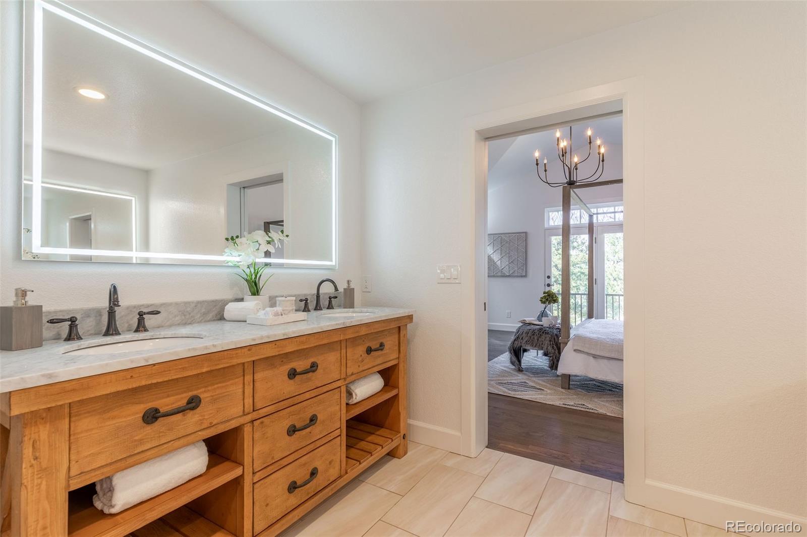 968 Summer Spring View Colorado Springs, CO 80906 - Photo 22 of 40 a bathroom with a granite countertop sink mirror and toilet