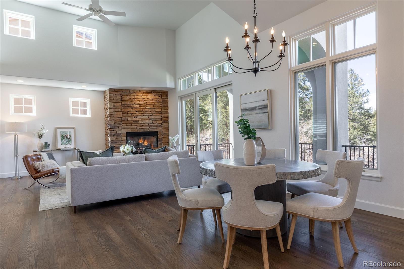 968 Summer Spring View Colorado Springs, CO 80906 - Photo 24 of 40 a living room with fireplace furniture and a chandelier