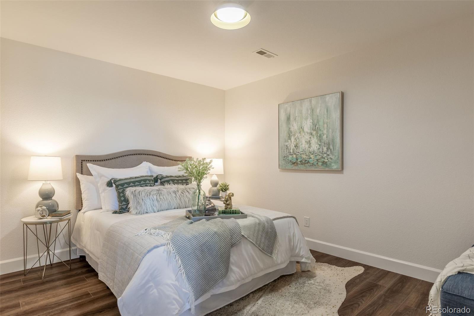 968 Summer Spring View Colorado Springs, CO 80906 - Photo 27 of 40 a bedroom with a bed and a lamp