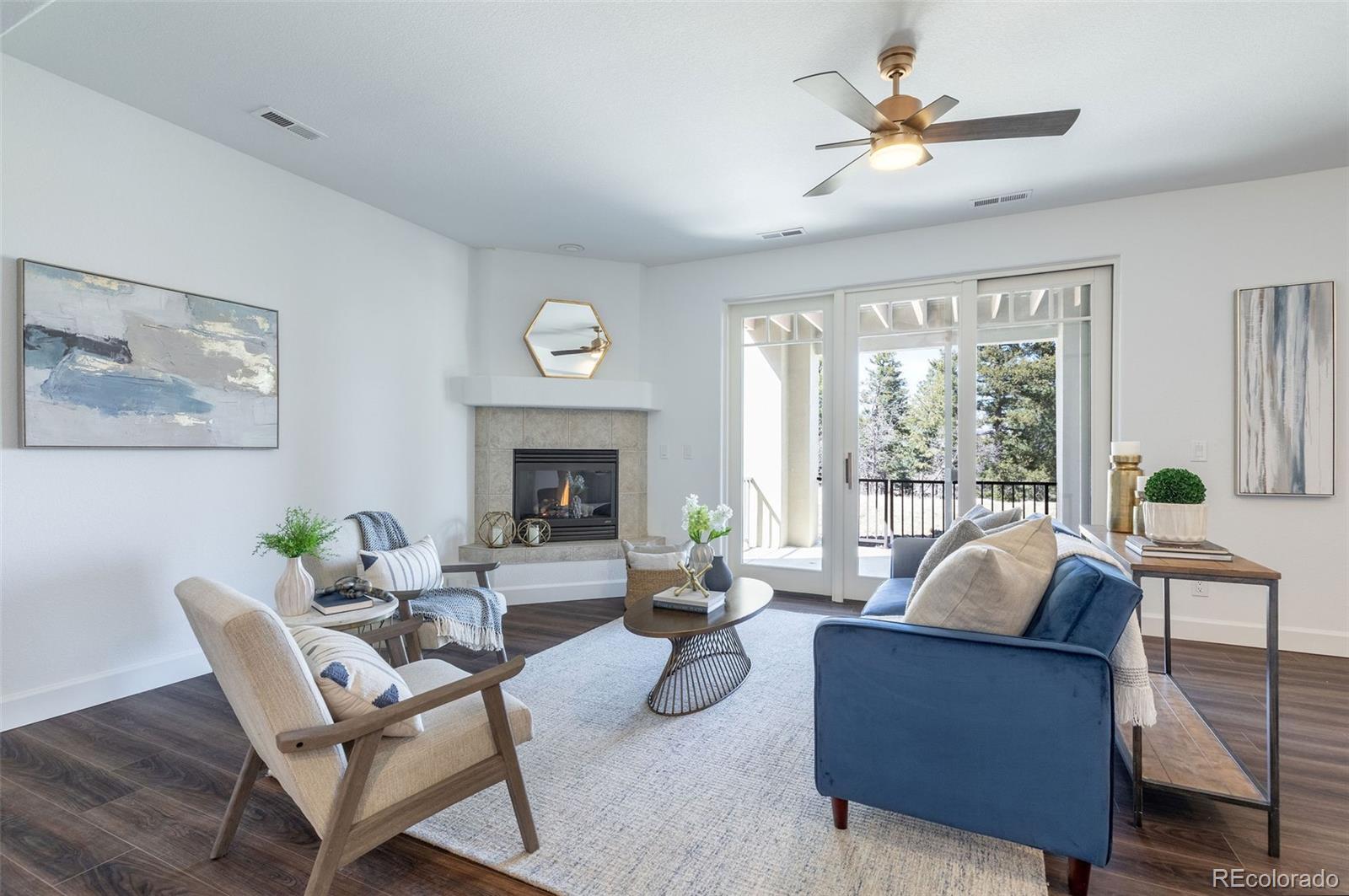 968 Summer Spring View Colorado Springs, CO 80906 - Photo 28 of 40 a living room with furniture fireplace and a large window