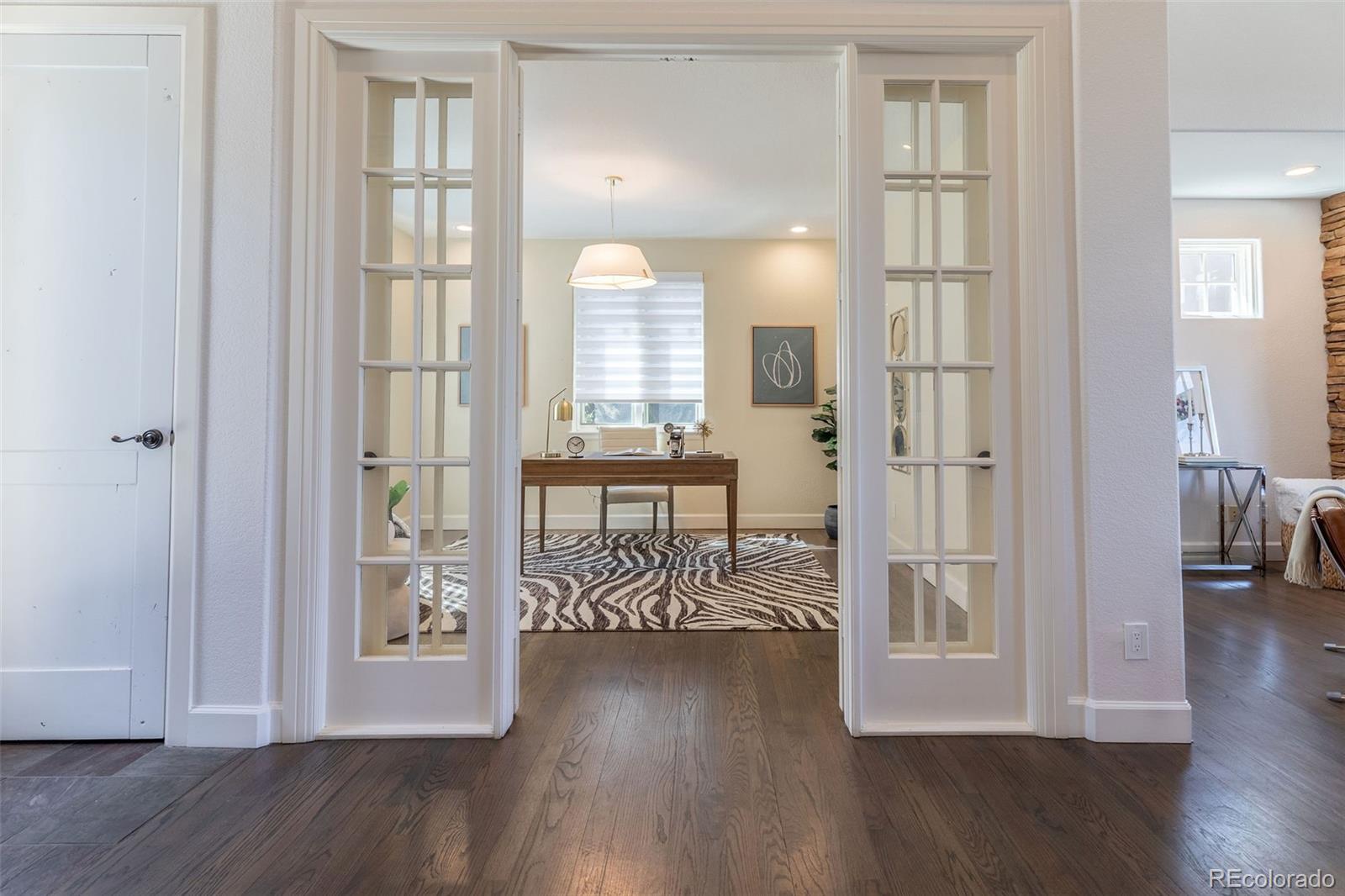 968 Summer Spring View Colorado Springs, CO 80906 - Photo 3 of 40 a view of front door with dining room and wooden floor