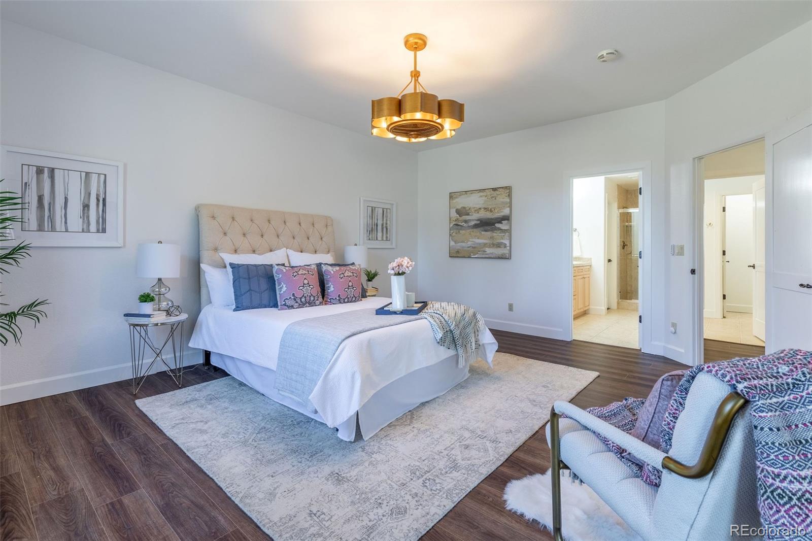 968 Summer Spring View Colorado Springs, CO 80906 - Photo 32 of 40 a bedroom with a bed and a chandelier