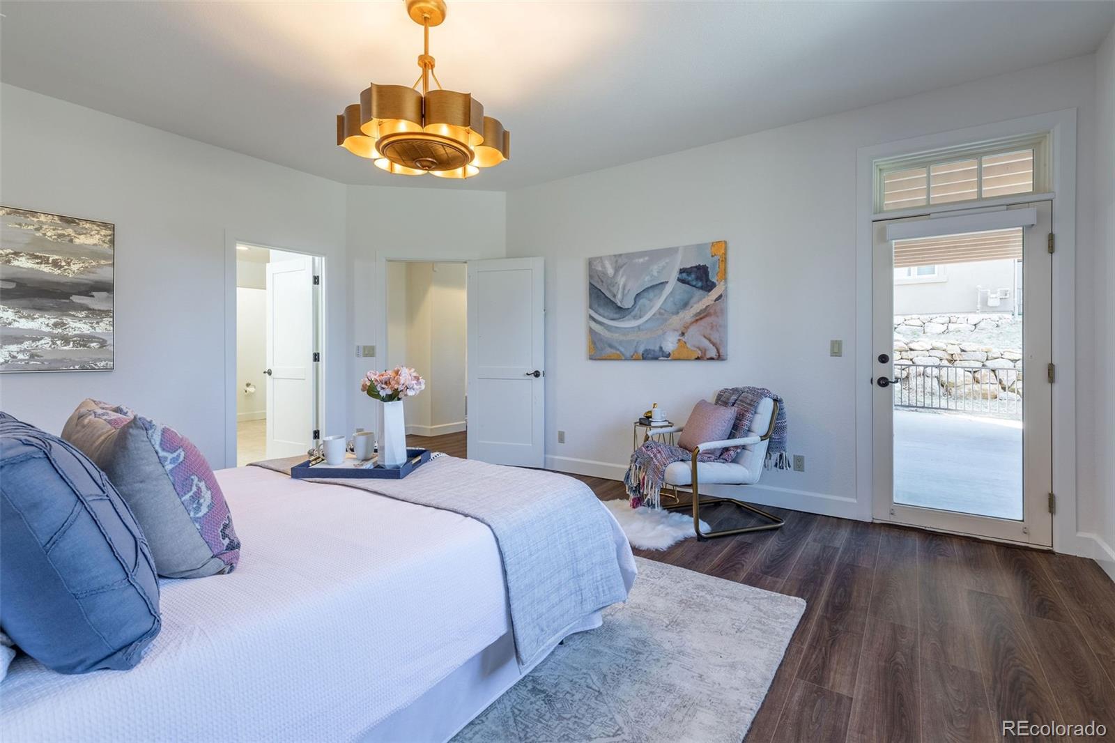 968 Summer Spring View Colorado Springs, CO 80906 - Photo 33 of 40 a bed room with a bed and a chandelier