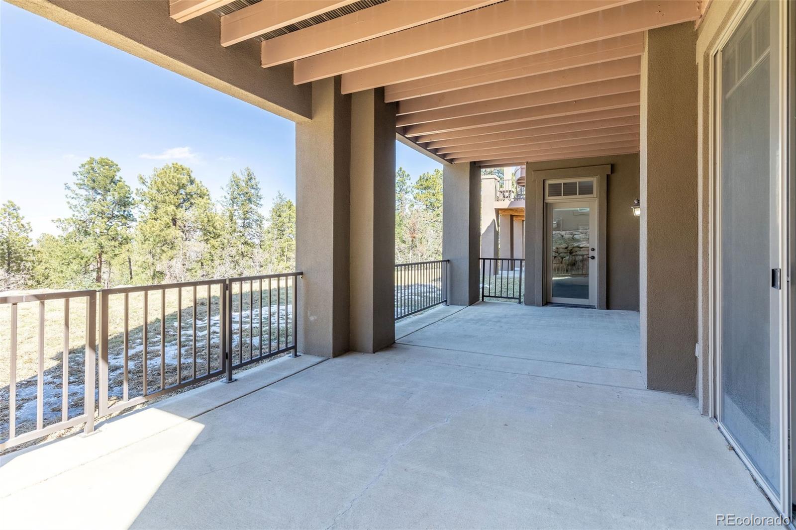 968 Summer Spring View Colorado Springs, CO 80906 - Photo 34 of 40 a view of a porch with wooden floor and fence
