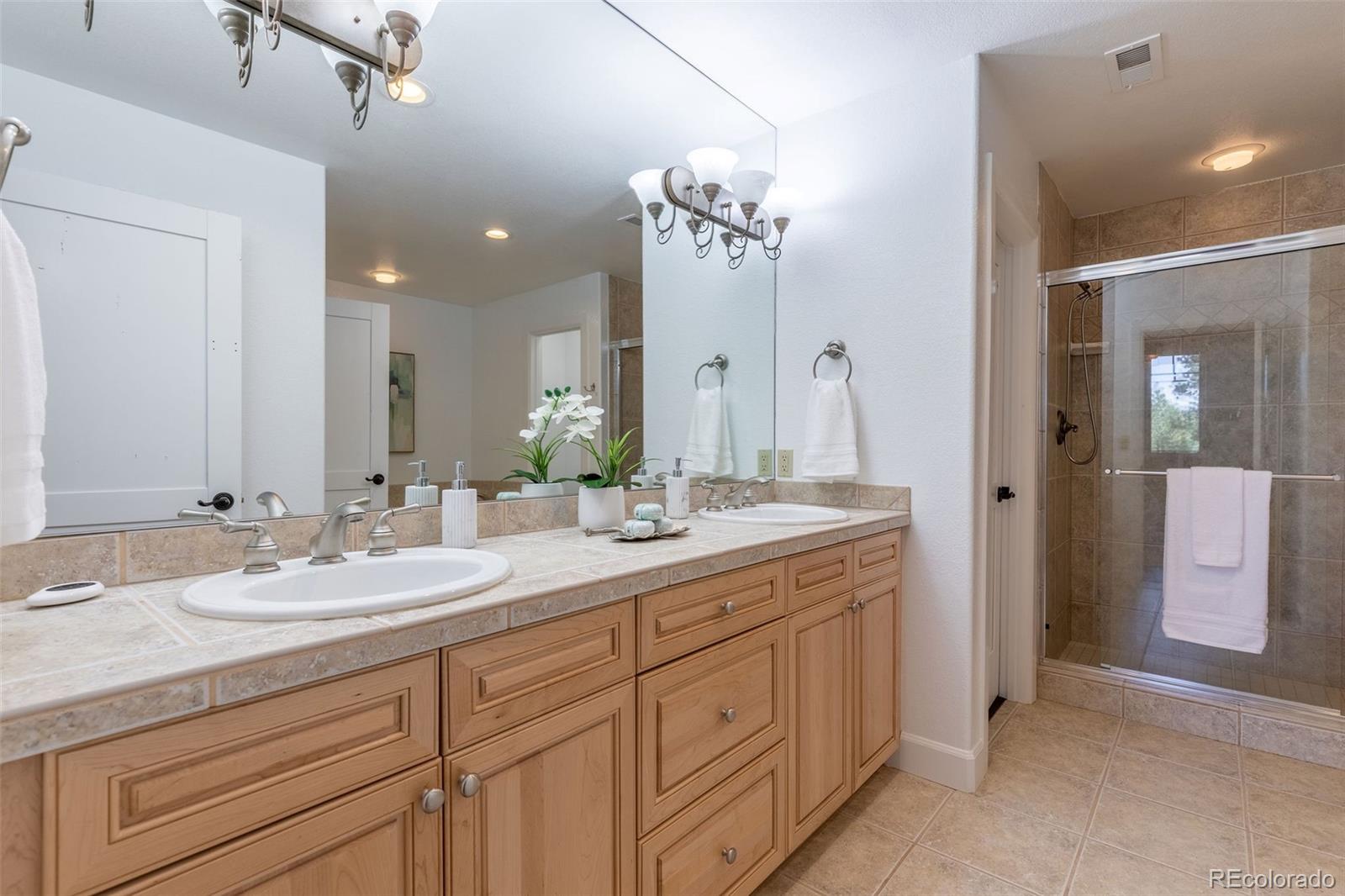 968 Summer Spring View Colorado Springs, CO 80906 - Photo 35 of 40 a bathroom with a granite countertop sink double and mirror