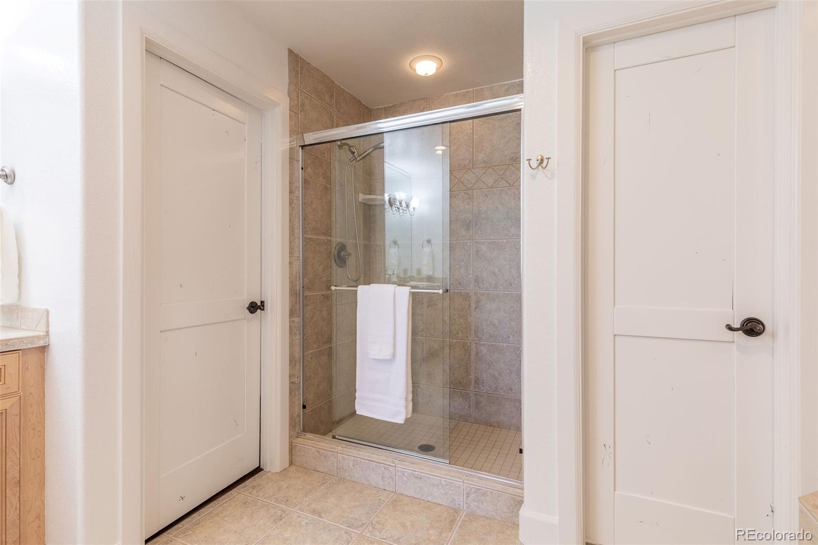 968 Summer Spring View Colorado Springs, CO 80906 - Photo 36 of 40 a bathroom with a glass shower door