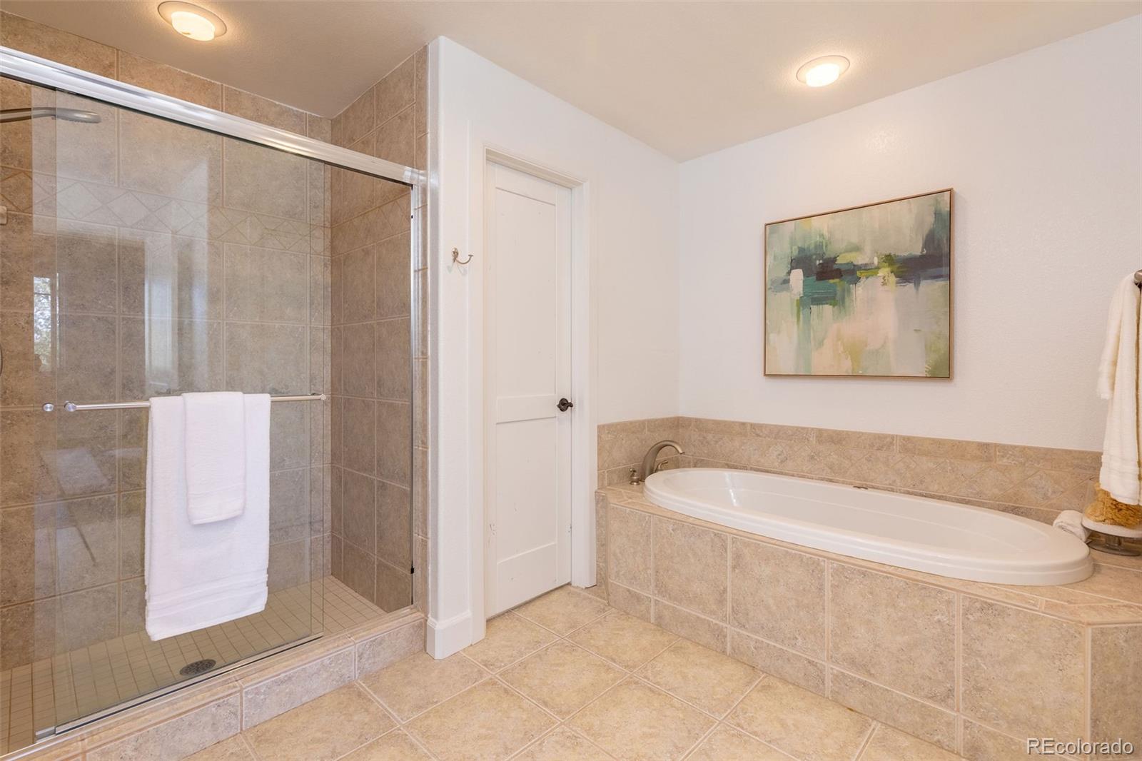 968 Summer Spring View Colorado Springs, CO 80906 - Photo 37 of 40 a bathroom with a bathtub and a shower