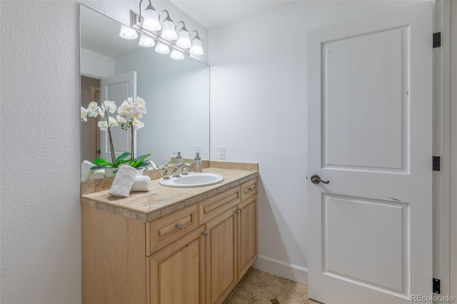 968 Summer Spring View Colorado Springs, CO 80906 - Photo 39 of 40 a bathroom with a sink vanity and a mirror