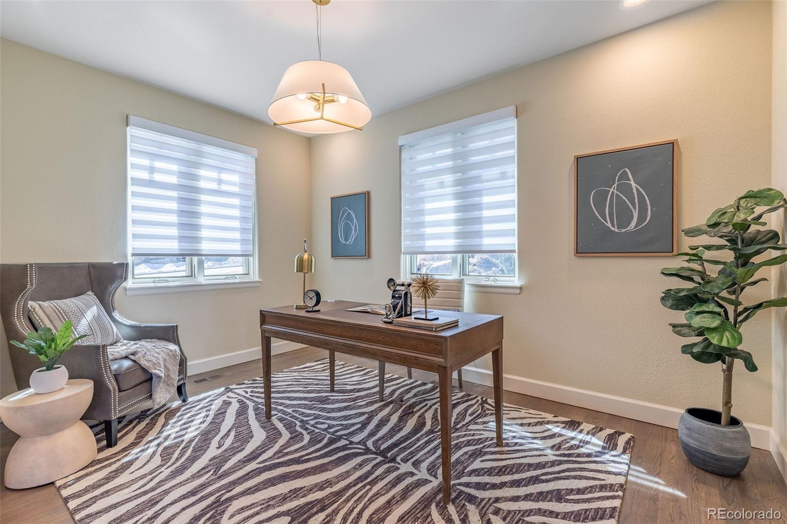 968 Summer Spring View Colorado Springs, CO 80906 - Photo 4 of 40 a view of a work space with furniture window and wooden floor