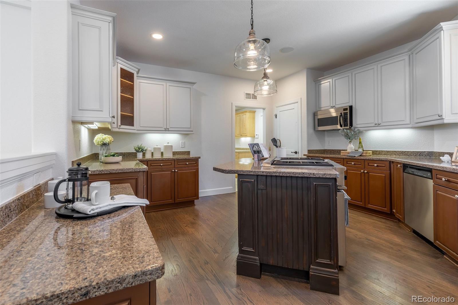 968 Summer Spring View Colorado Springs, CO 80906 - Photo 5 of 40 a kitchen with kitchen island granite countertop stainless steel appliances stove a sink and cabinets