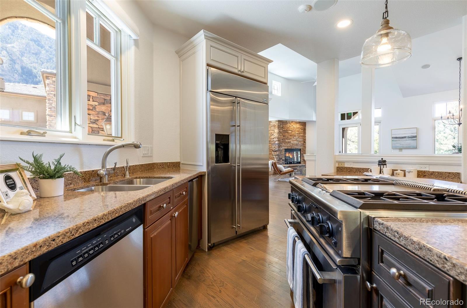 968 Summer Spring View Colorado Springs, CO 80906 - Photo 7 of 40 a kitchen that has a sink and a stove