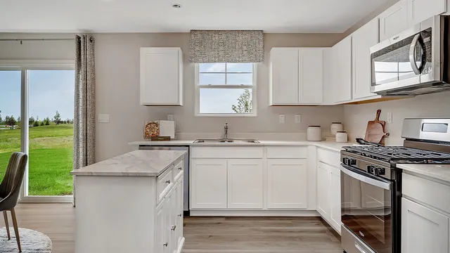 a kitchen with a sink stove and cabinets