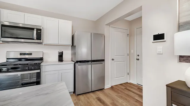a kitchen with stainless steel appliances a refrigerator stove and microwave