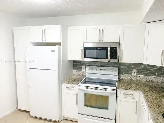 a kitchen with a stove microwave and refrigerator