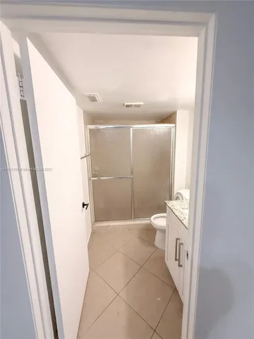 a bathroom with a shower and a toilet