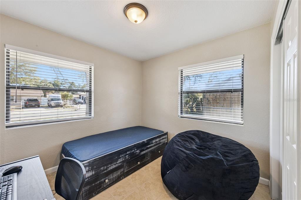 725 3rd Street Orange City, FL 32763 - Photo 13 of 15 a room with furniture and a window