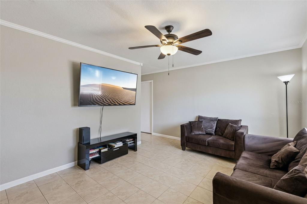 725 3rd Street Orange City, FL 32763 - Photo 2 of 15 a living room with furniture and a flat screen tv