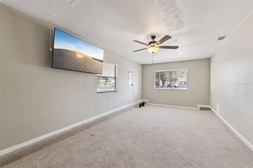 725 3rd Street Orange City, FL 32763 - Photo 4 of 15 an empty room with windows and ceiling fan