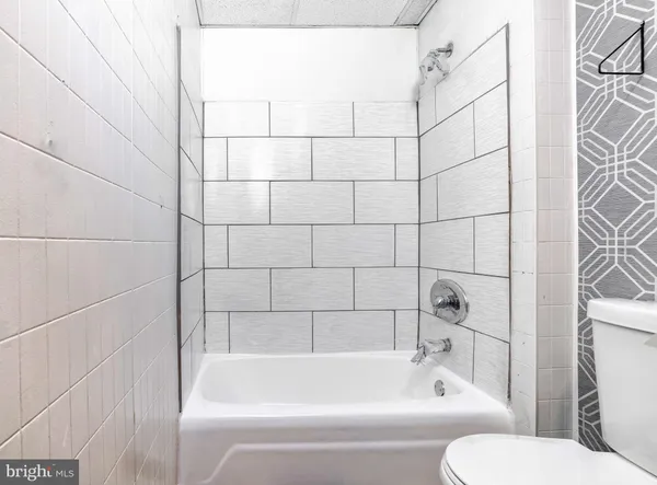a bathroom with a bathtub and a toilet