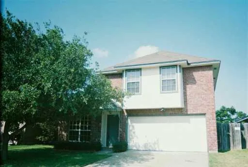 a house that has tree in front of it