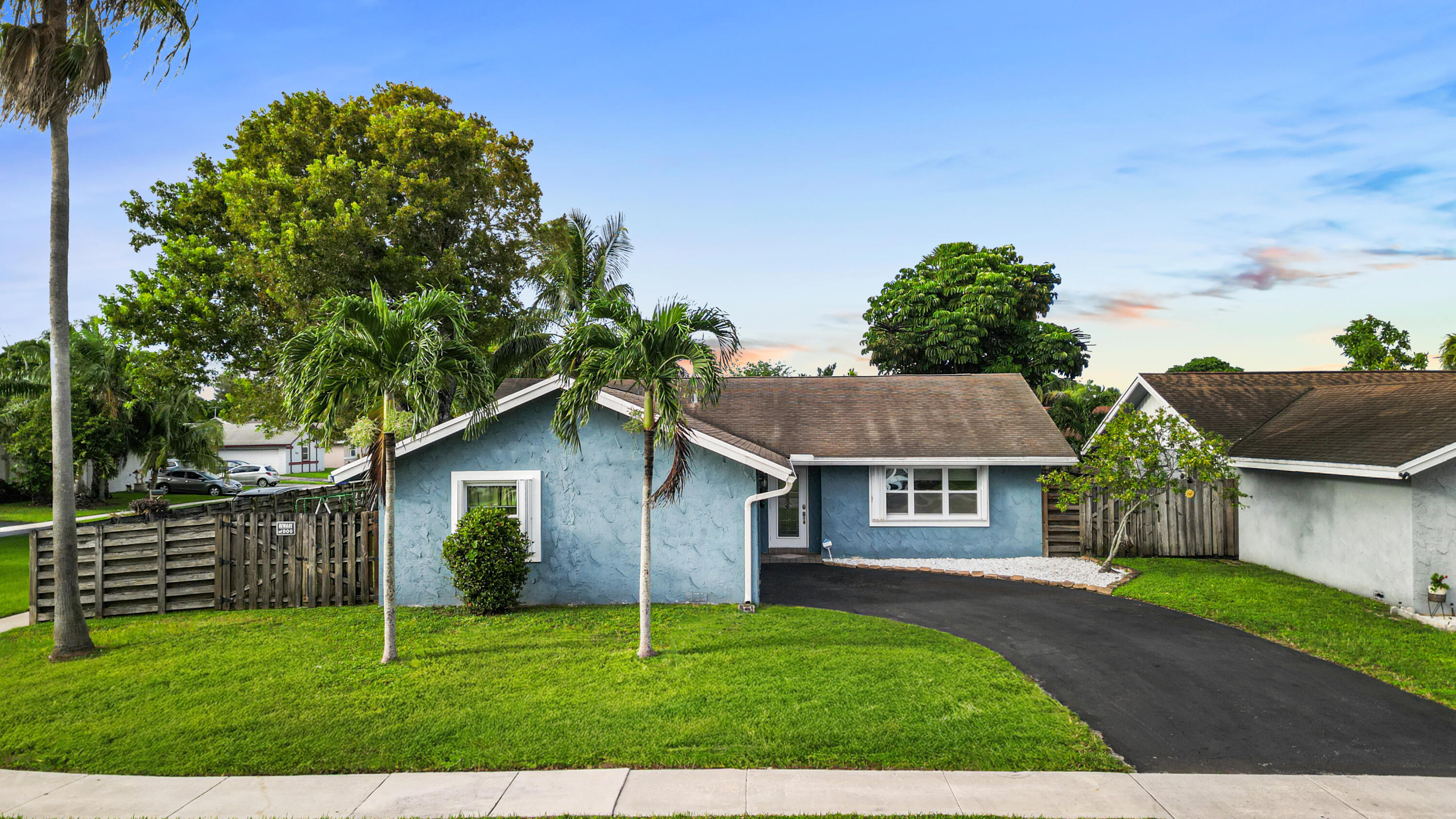 a house that has a tree in front of it