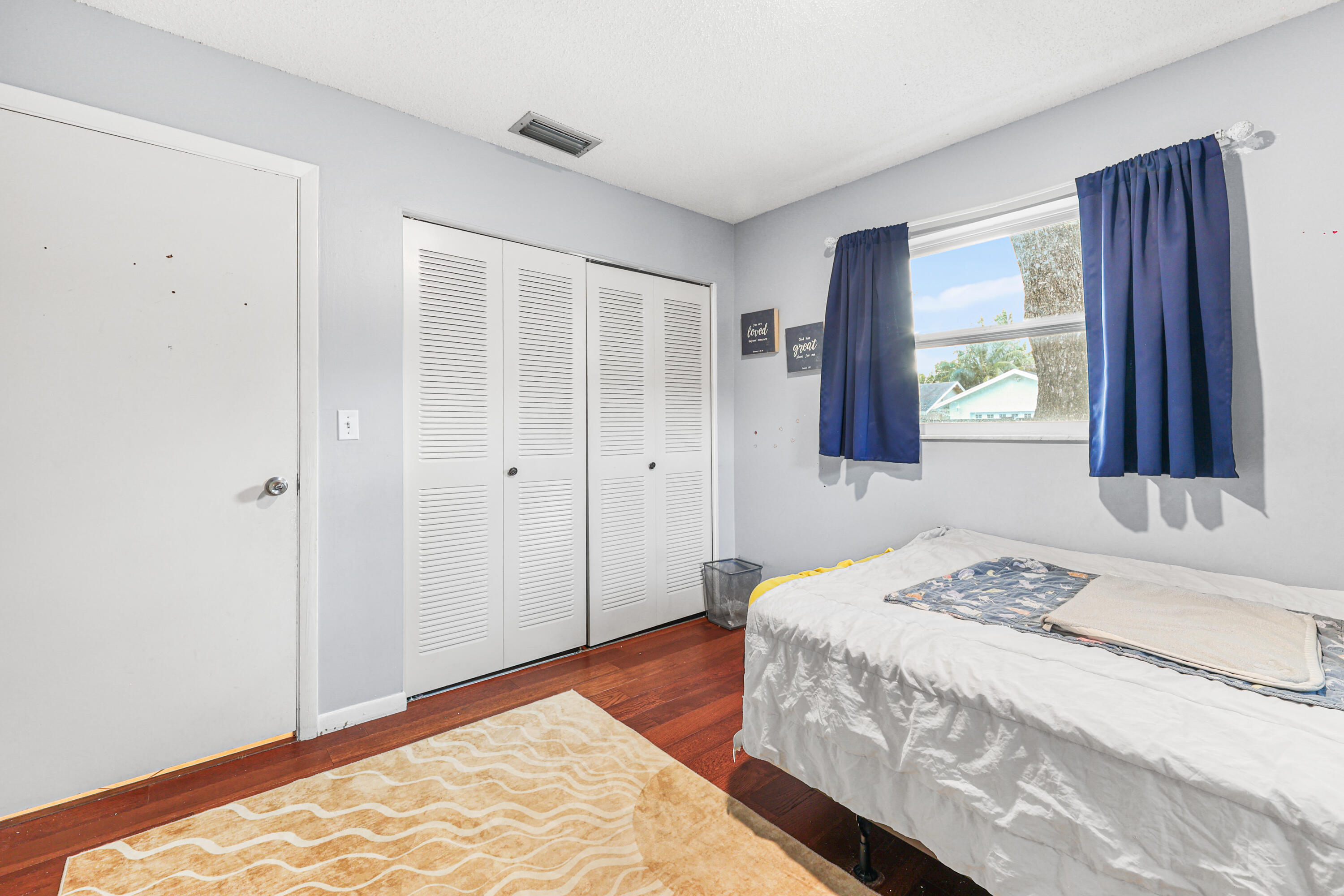 7527 Southwest 7th Street North Lauderdale, FL 33068 - Photo 13 of 34 a bedroom with a bed and a window